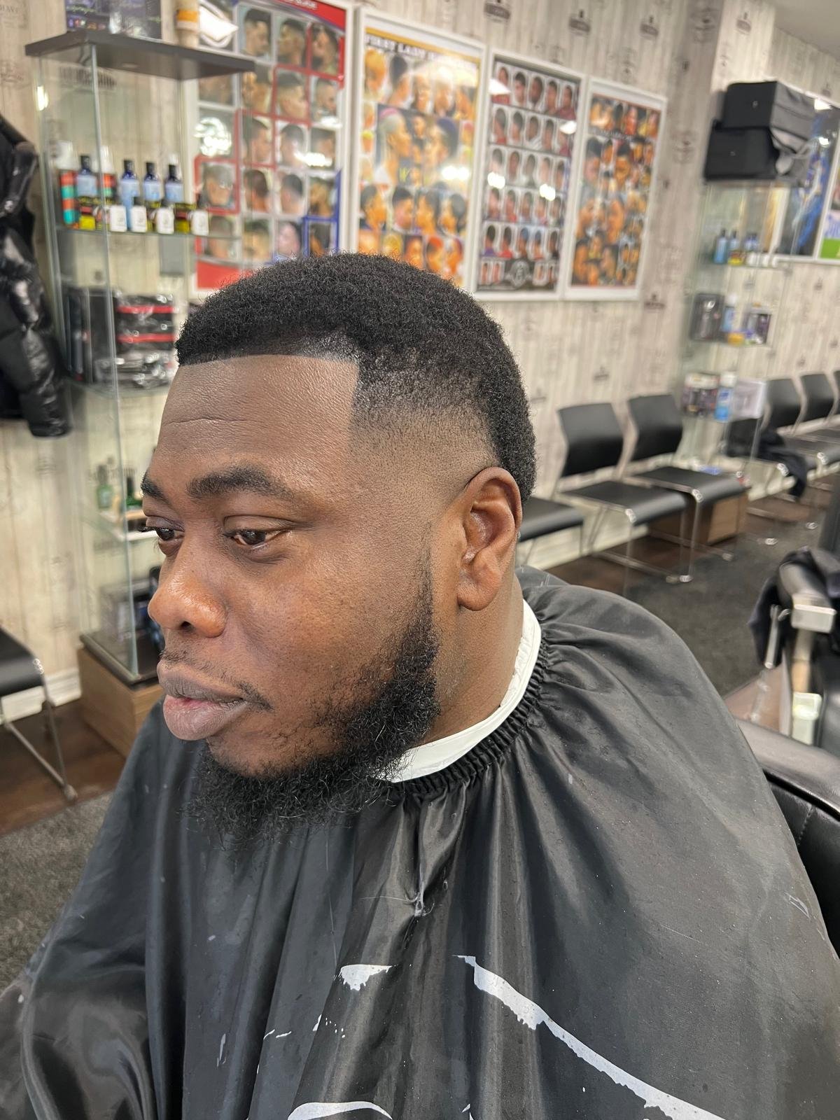 Low fade with a full shaped beard and crisp line-up